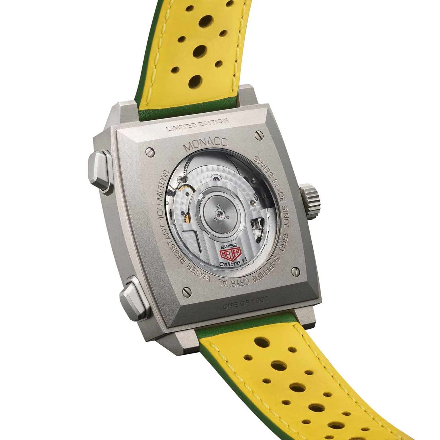 The TAG Heuer Monaco Chronograph Racing Green showcases its automatic movement through a clear caseback, complemented by a yellow perforated strap and limited edition engraving.