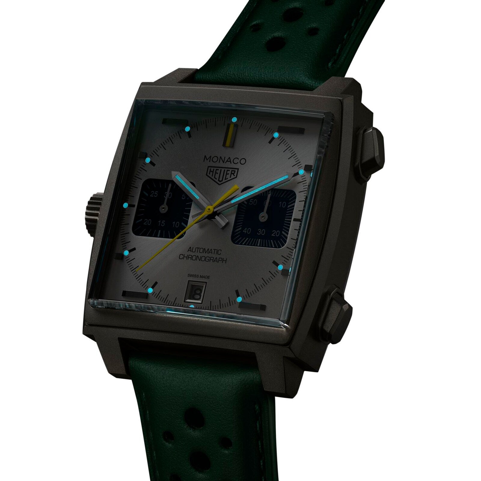 The TAG Heuer Monaco Chronograph Racing Green features a square case, gray dial, two black subdials, yellow chronograph hand, and a Racing Green perforated leather strap with Calibre 11 movement.