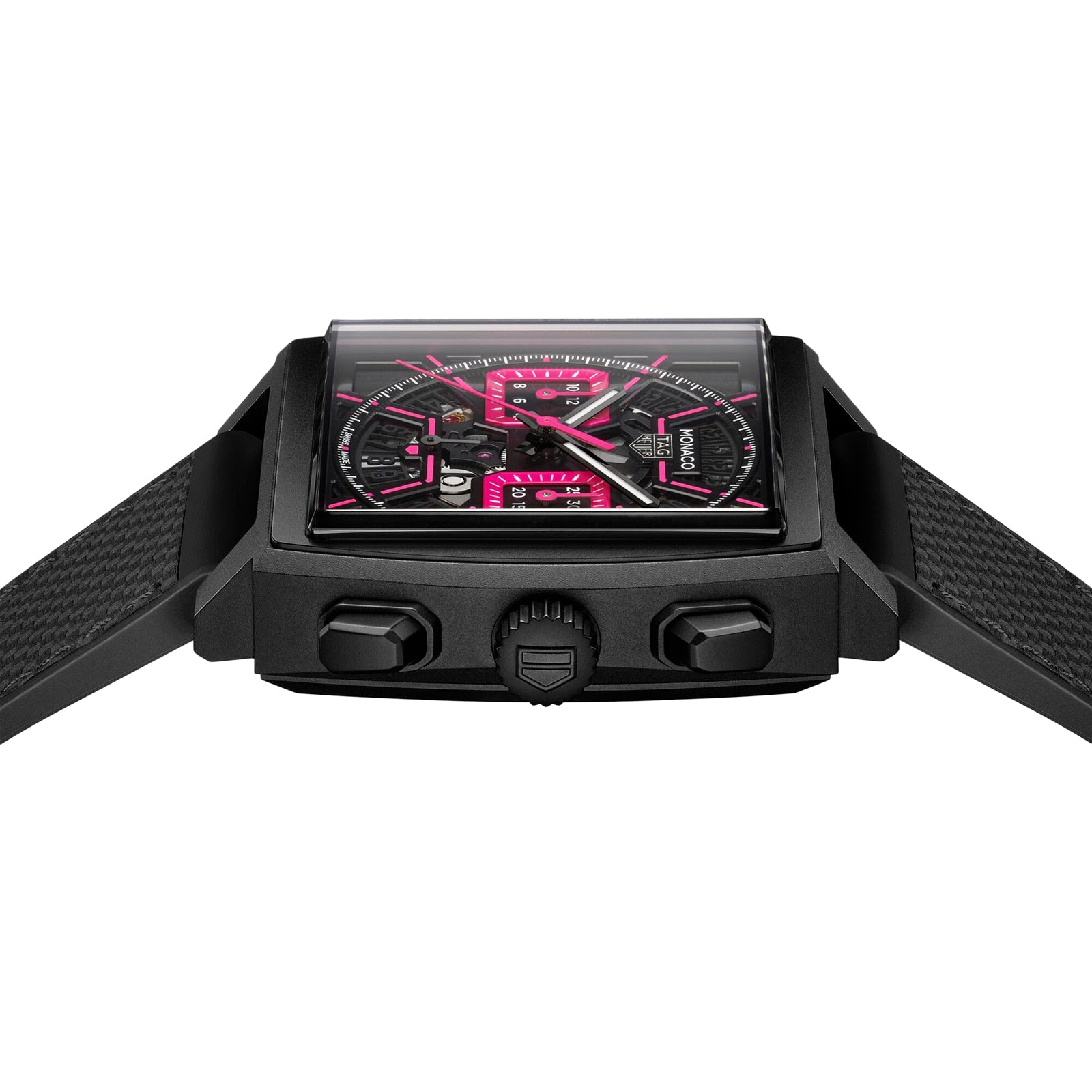 The TAG Heuer Monaco Chronograph features a square titanium case, black dial with pink accents, textured strap, and three side buttons, photographed on a white background.