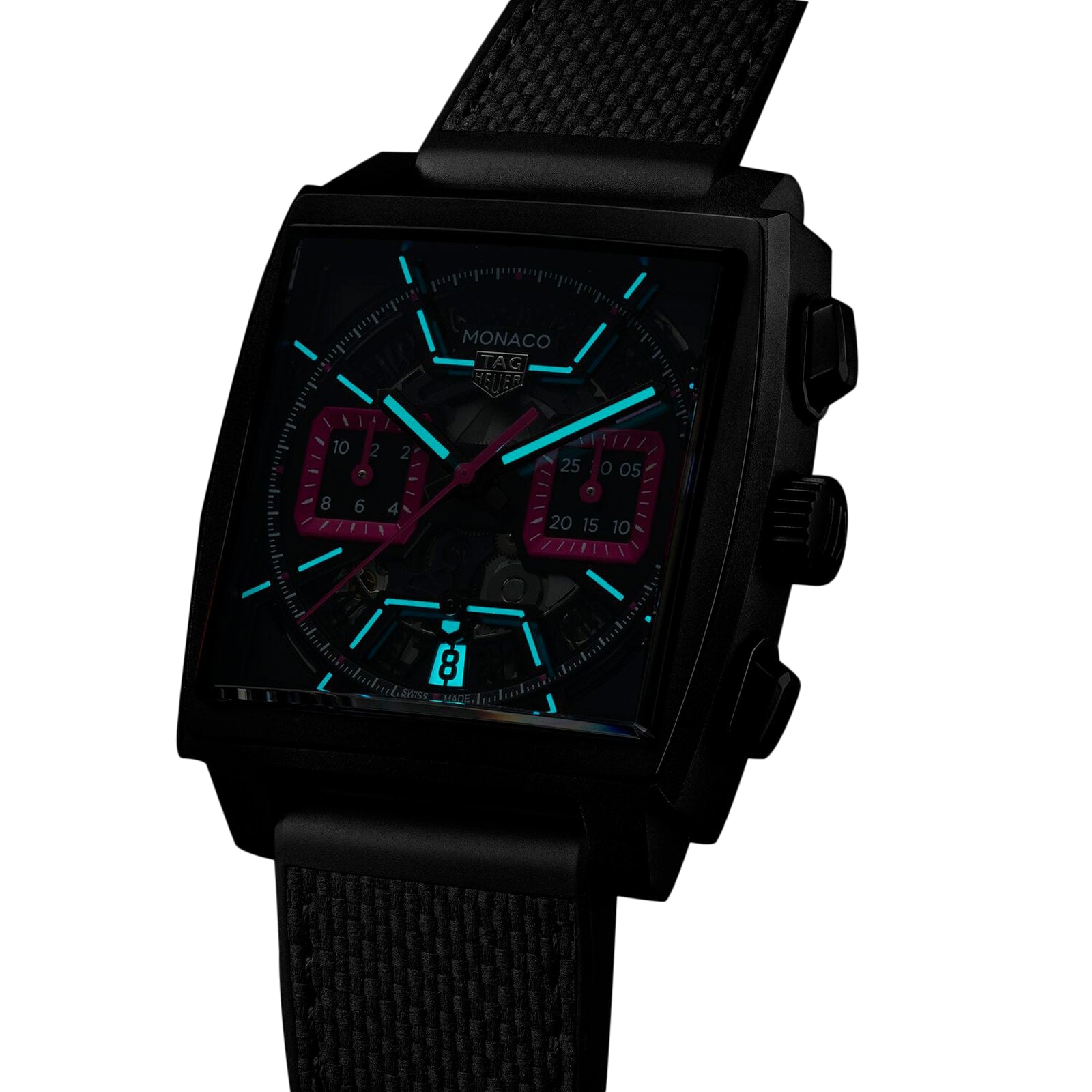 The TAG Heuer Monaco Chronograph features a black square titanium case, illuminated blue hour markers, red subdials, pink accents, and a black textured strap, displayed against a white background.