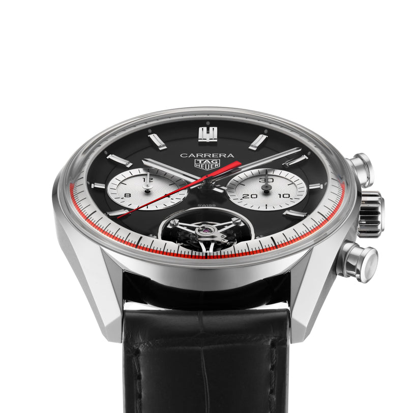 The TAG Heuer Carrera Tourbillon Centenary The Watches of Switzerland Group Exclusive features a black dial, two subdials, red accents, and a black leather strap, presented at an angle.