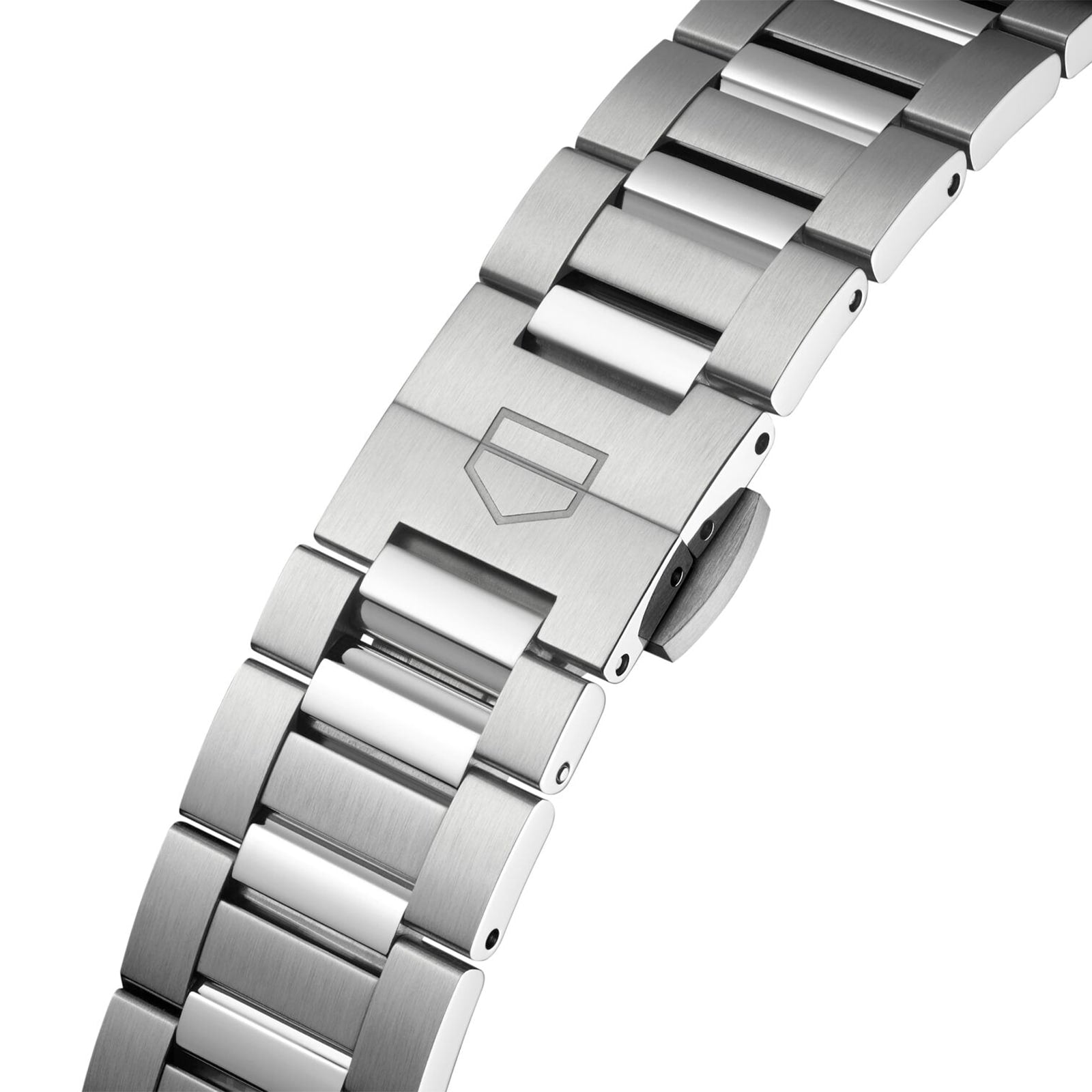 Close-up of a stainless steel TAG Heuer Carrera Date bracelet with a fold-over clasp and engraved shield logo, powered by the Calibre 7 automatic movement—a tribute to the daring spirit of the Panamericana race.