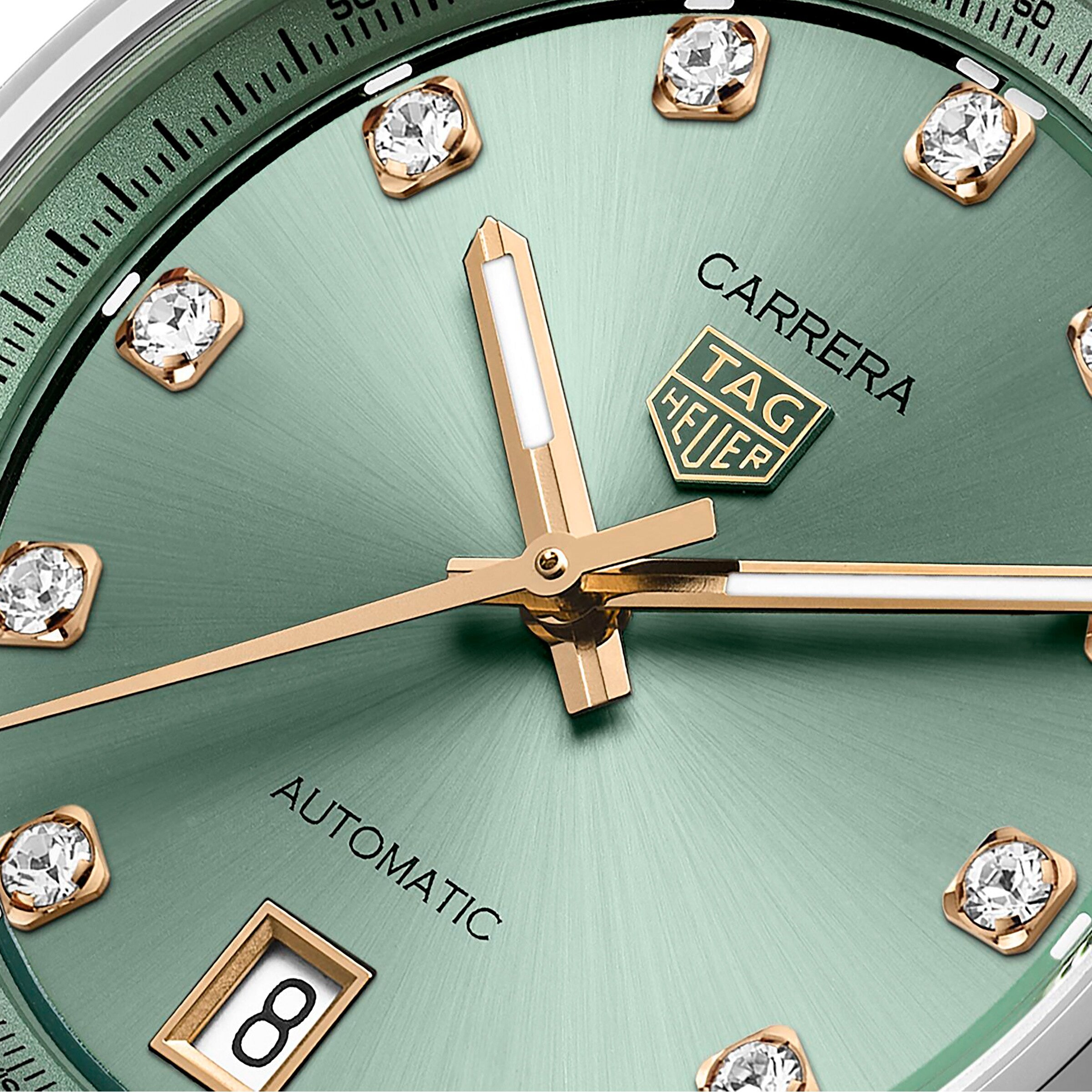 Close-up of the TAG Heuer Carrera Date, showcasing its green sunray-brushed dial with gold hands, diamond hour markers, and a date window at 6 o’clock.