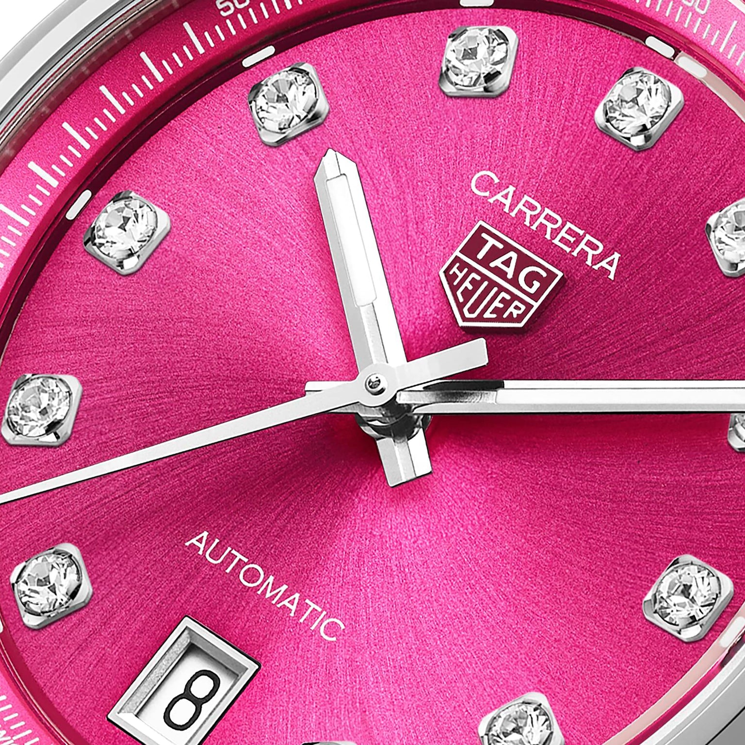 Close-up of the TAG Heuer Carrera Date watch face with a pink snail-brushed dial, VS diamond hour markers, date window, and silver hands.
