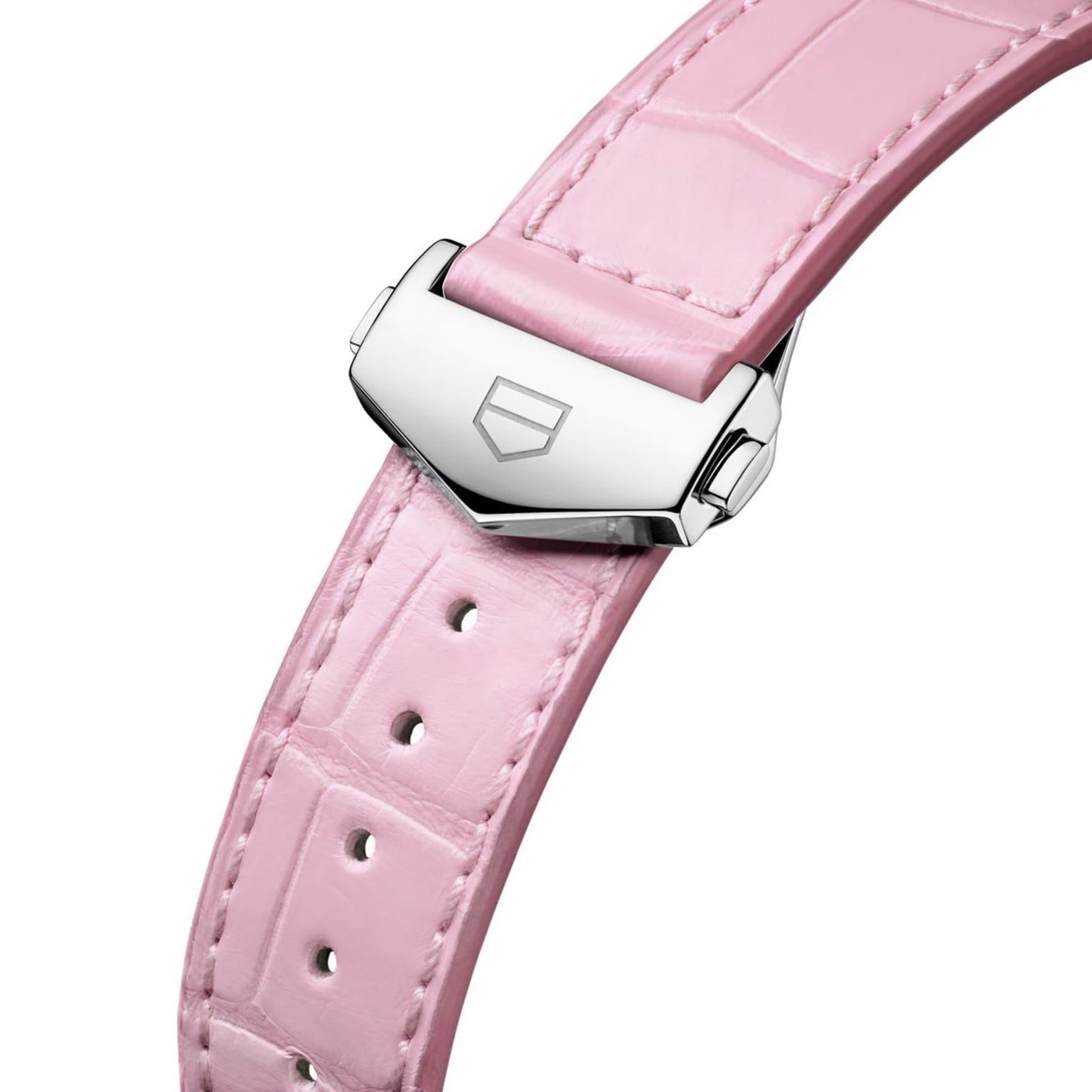 Close-up of a pink leather watch strap with a silver buckle and engraved geometric logo. Pair it with the TAG Heuer Carrera Calibre 7 for timeless sophistication, featuring TAG Heuer’s signature style and elegant design.