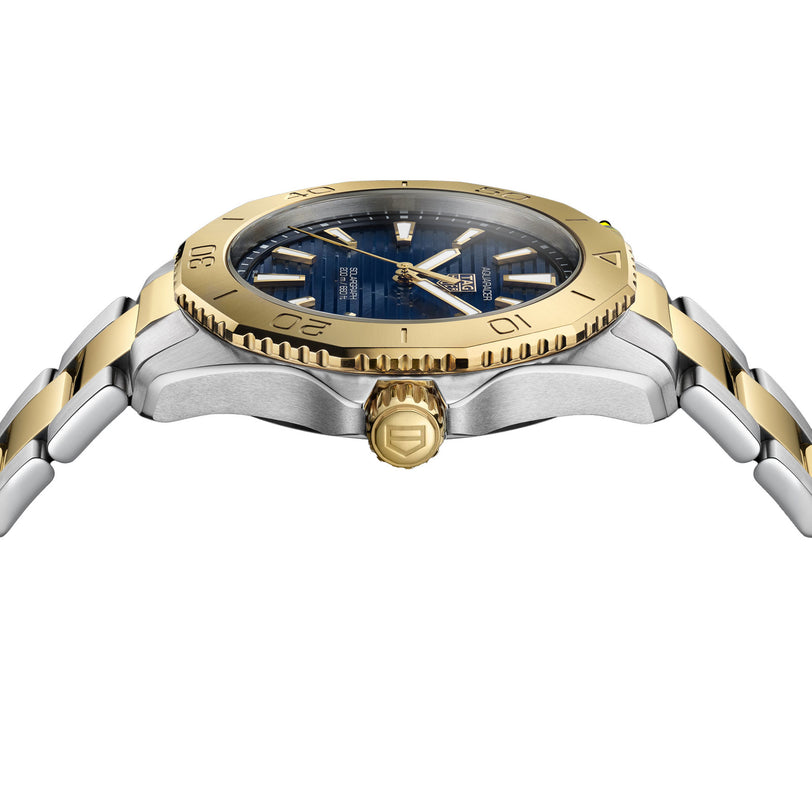 Side view of a TAG Heuer Aquaracer Professional 200 Solargraph with a gold bezel, blue dial, and two-tone bracelet featuring gold center links.