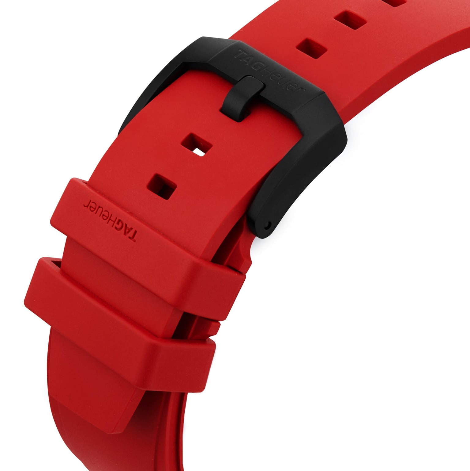 Close-up of a red TAG Heuer Formula 1 Chronograph rubber strap with a black buckle, adjustment holes, and the TAG Heuer branding on the strap loop.
