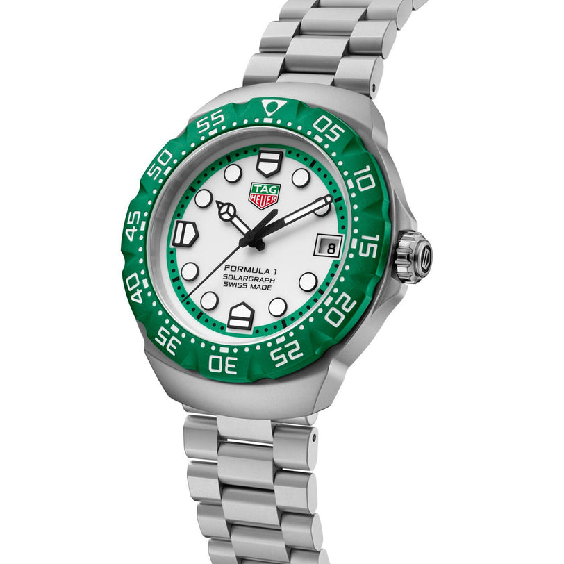 The TAG Heuer Formula 1 Solargraph features a green bezel, white dial, silver band, and bold hour markers.