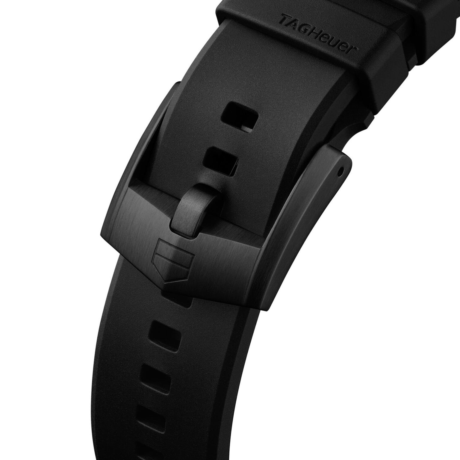 Close-up of the TAG Heuer Formula 1 Solargraph’s black strap with a matte black buckle and shield logo.