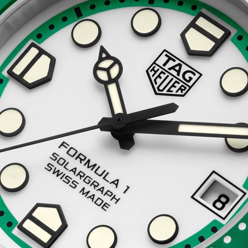 Close-up of a TAG Heuer Formula 1 Solargraph watch face featuring a white dial with green accents.