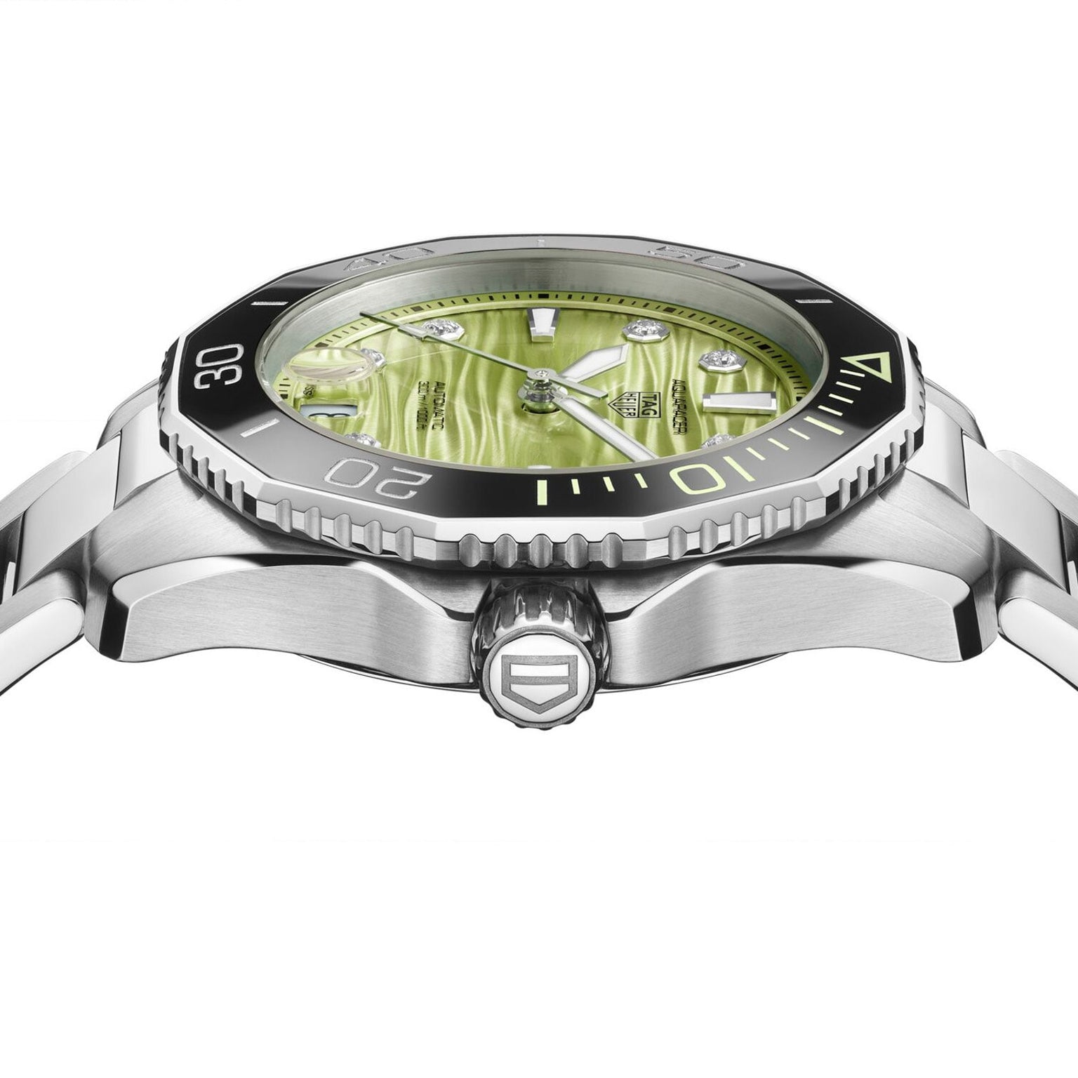 Side view of the TAG Heuer L SS AU BW AQUAR 300 36 GRN DD DL 25, a silver wristwatch featuring a green textured dial and black bezel, shown on a white background.