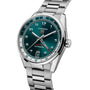 A TAG Heuer Carrera Date Twin-Time watch with a silver case, teal face, and silver bracelet, displaying the time 10:10.