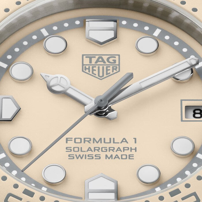 TAG Heuer Formula 1 Solargraph watch face with cream dial, silver hands, round indices, and steel case.