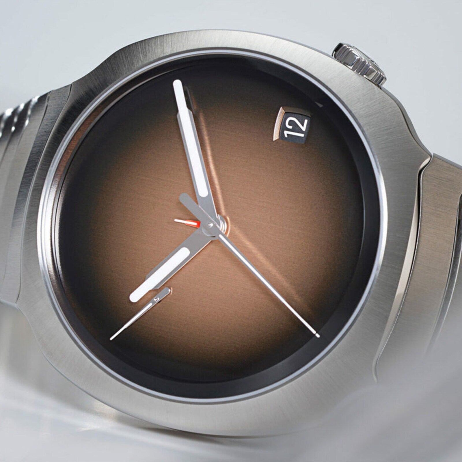 Close-up of the H. Moser & Cie Streamliner Perpetual Calendar, featuring a brown gradient dial, silver hands, and a date window displaying 12.