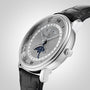 The Blancpain Villeret Quantième Complet is a luxury silver wristwatch featuring Roman numerals, a moonphase display, and a black leather strap, shown against a light background.