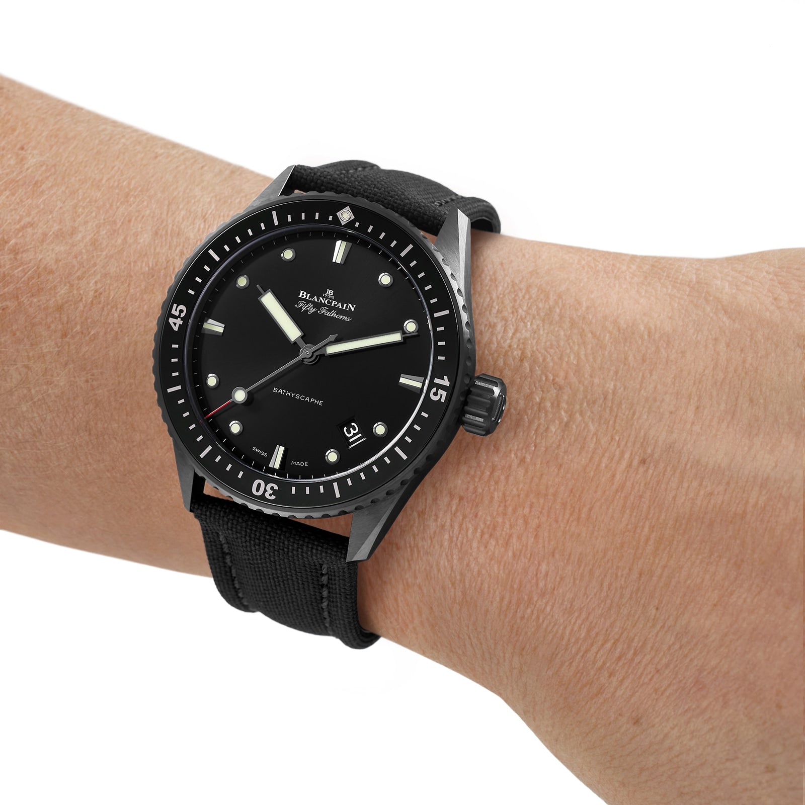 A person wearing a Blancpain Fifty Fathoms Bathyscaphe with a ceramic case, black dial, white markers, and a black fabric strap.