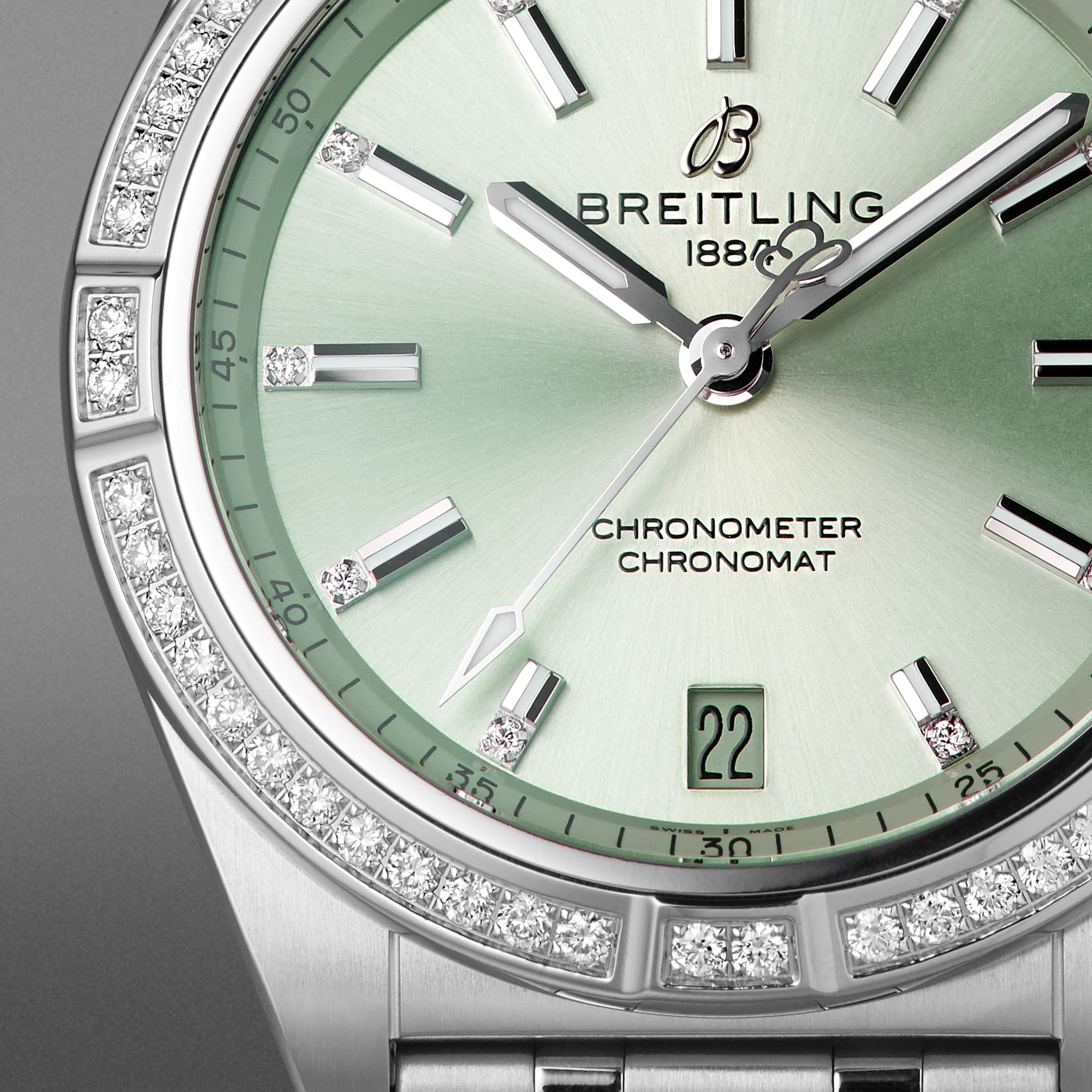 Close-up of the Breitling Chronomat Automatic 36, featuring a green dial, diamond-set bezel, date window at 6 oclock, and signature Rouleaux bracelet.