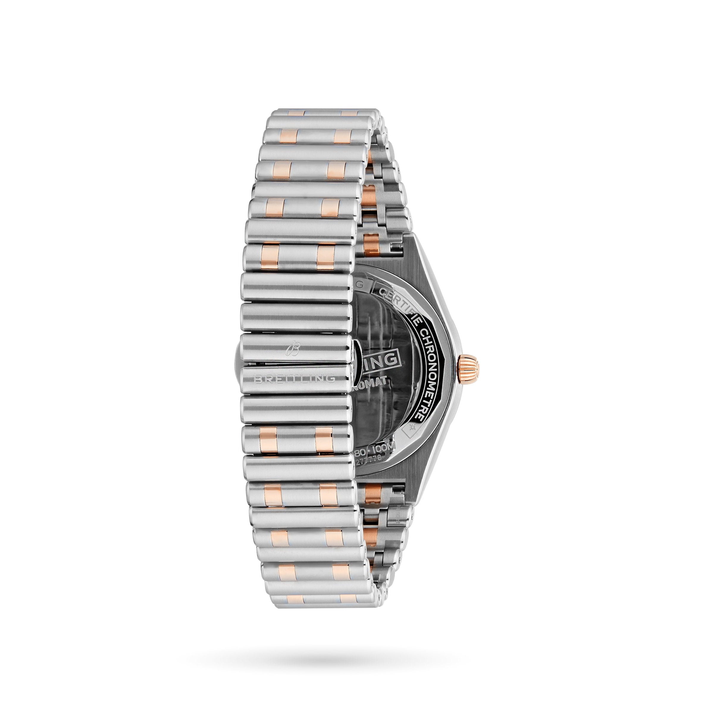 The Breitling Chronomat Automatic 36 is shown from the back at a side angle, highlighting its silver and gold bracelet, partially visible engraved caseback, and elegant diamond-set bezel.