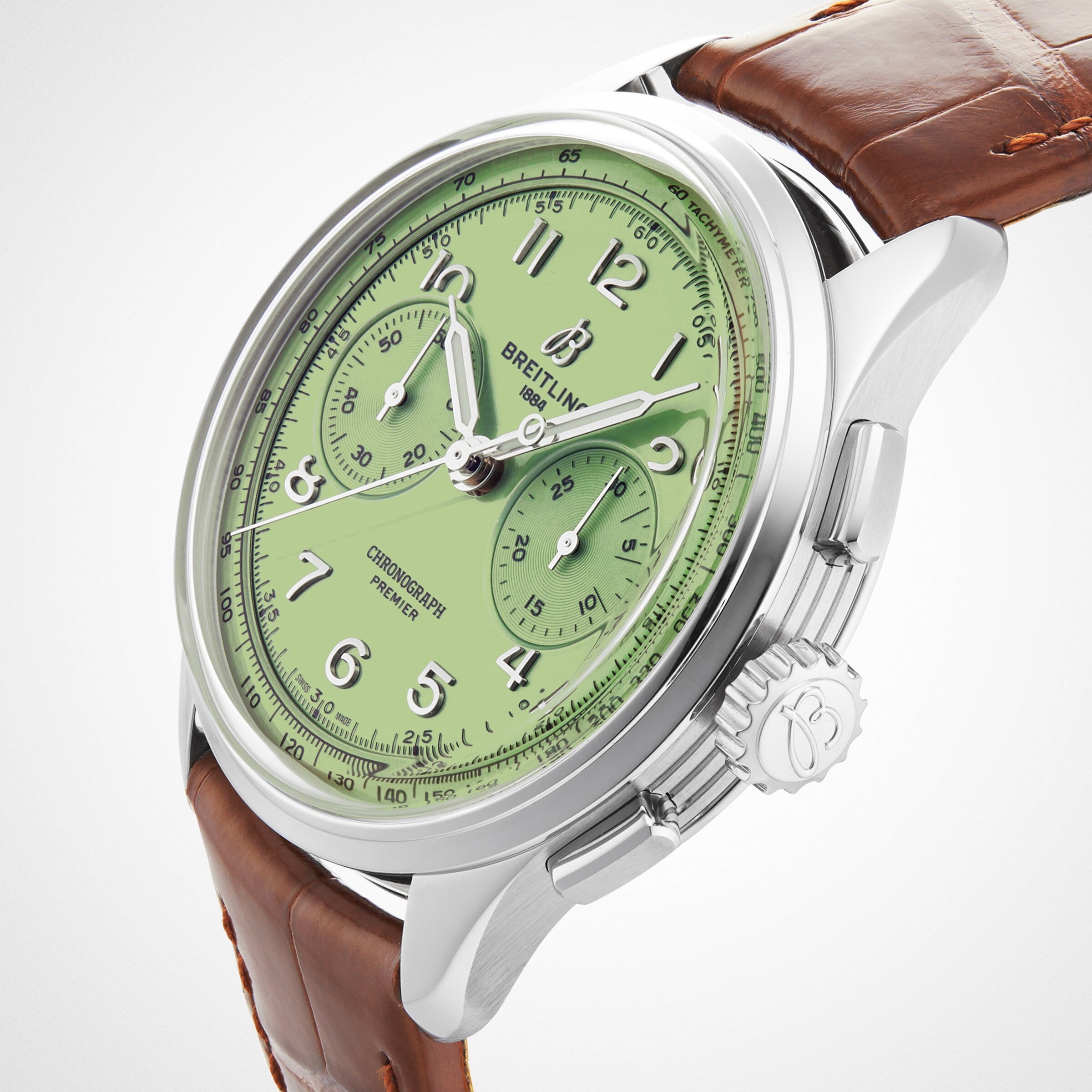 The Breitling Premier B09 Chronograph 40 features a light green dial, silver case, and brown leather strap with a precise B09 calibre movement, shown angled on a white background.