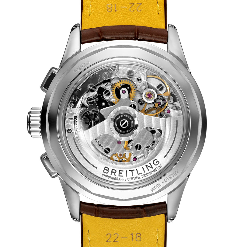Close-up of the Premier B25 Datora 42 by Breitling, showcasing its transparent caseback that reveals the intricate mechanical movement and inner workings, complemented by a yellow leather strap.