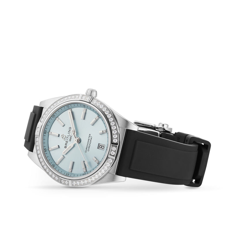 The Breitling Chronomat Automatic 36 stainless steel wristwatch features a silver and diamond-accented bezel, light blue dial with date display, and black rubber strap, showcased on a white background.