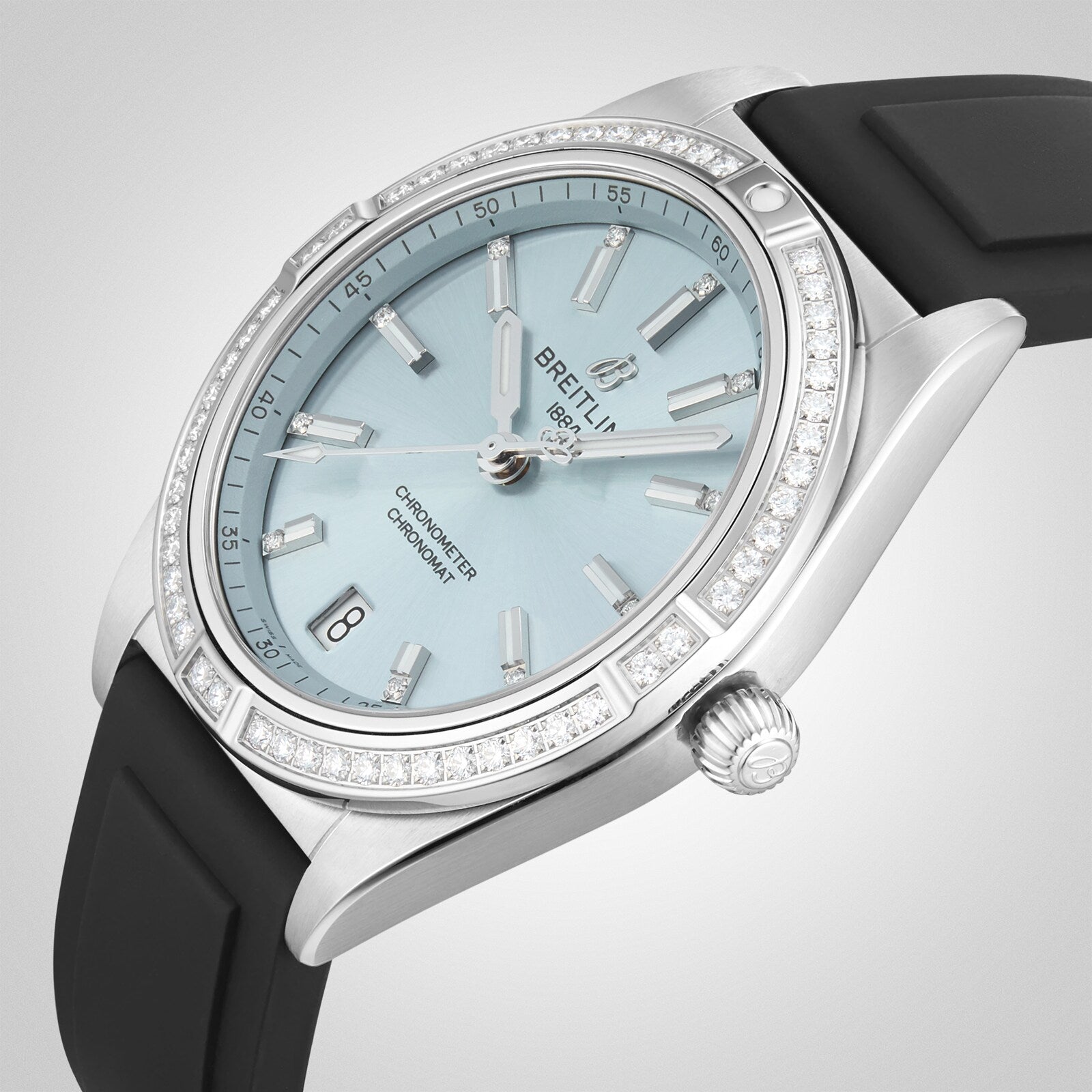 A Breitling Chronomat Automatic 36 wristwatch with a light blue dial, diamond bezel, automatic movement, date display, and black rubber strap is pictured against a light background.