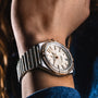 Close-up of a Breitling Chronomat Automatic 36 wristwatch in silver and gold with a diamond-set bezel and white dial, worn on the wrist. The COSC-certified timepiece shows date and time, paired with an elegant Rouleaux bracelet.