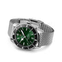 The Breitling Superocean Heritage B20 Automatic 42 is a stainless steel wristwatch with a green dial, silver mesh band, silver hour markers, date at 3 oclock, water resistance, shown on a white background.
