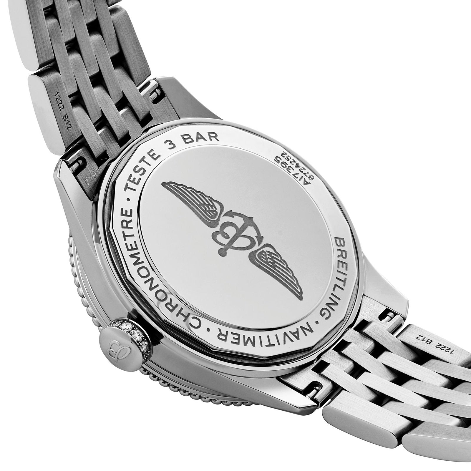 Close-up of the back of a Breitling Navitimer 32 watch highlighting its logo, detailed engravings, and sleek metal bracelet.