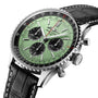 A close-up of the Breitling Navitimer B01 Chronograph 43, featuring a green dial with three black subdials, a black bezel, and a black leather strap with white stitching, powered by the Breitling 01 calibre.