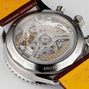 Close-up of the back of the Breitling Navitimer B01 Chronograph 41, showcasing its exposed mechanical movement, engraved branding, and brown leather strap.