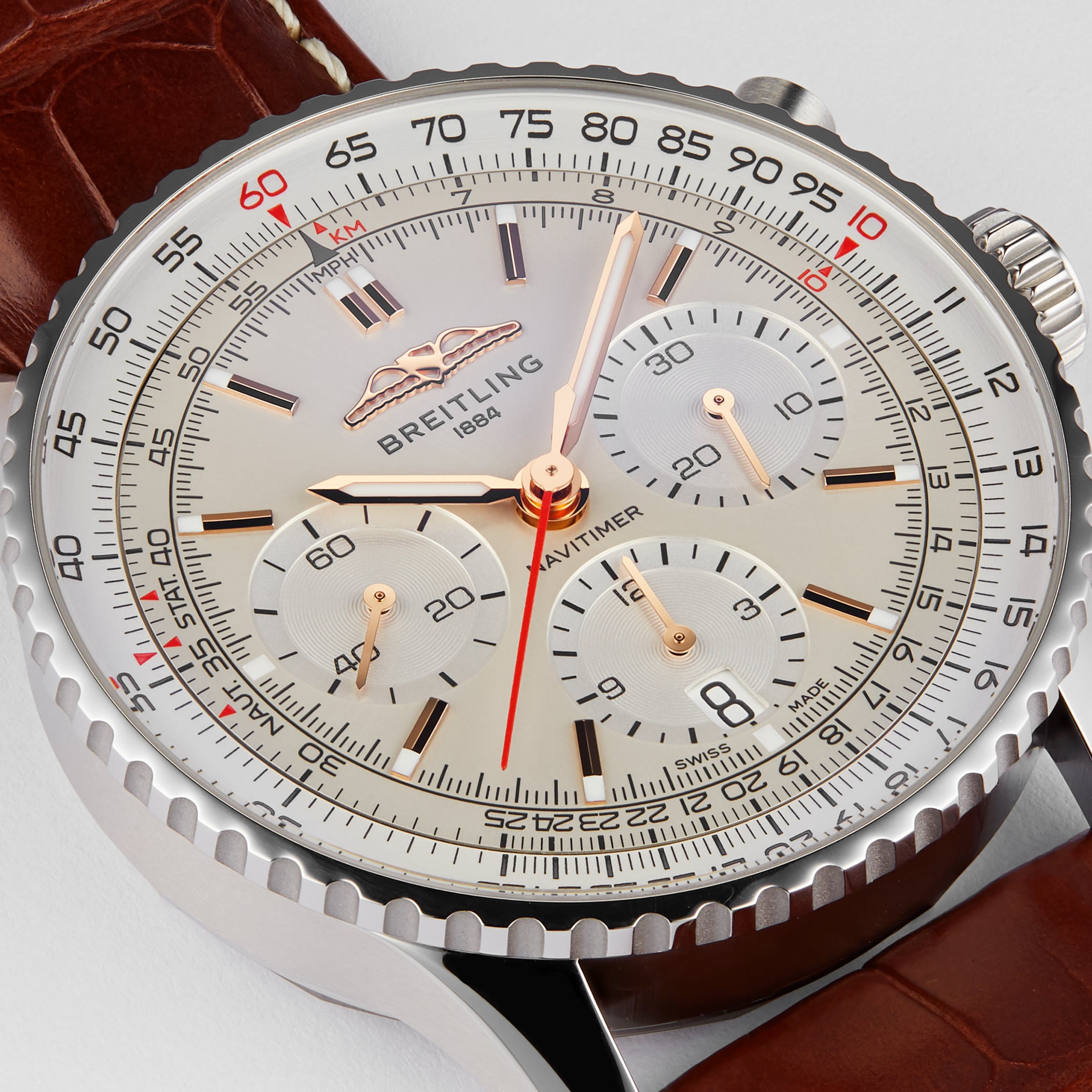 Close-up of a Breitling Navitimer B01 Chronograph 41 wristwatch with a silver dial, three subdials, date window, and brown leather strap. The time shown is 10:07:36.