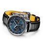 The Breitling Navitimer B01 Chronograph 41 features a silver case, black and blue dial, black leather strap with yellow inner lining, showcased against a white background.