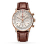 The Breitling Navitimer B01 Chronograph 41 features a white dial with three subdials, a gold case, brown leather strap, visible right-side pushers, and is powered by the renowned Breitling 01 calibre movement.