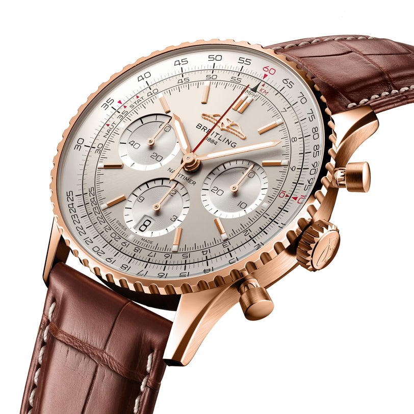 The Breitling Navitimer B01 Chronograph 41 features a gold case, cream dial with subdials, chronograph functions, and a brown leather strap—an iconic pilot’s watch powered by the Breitling 01 calibre movement.
