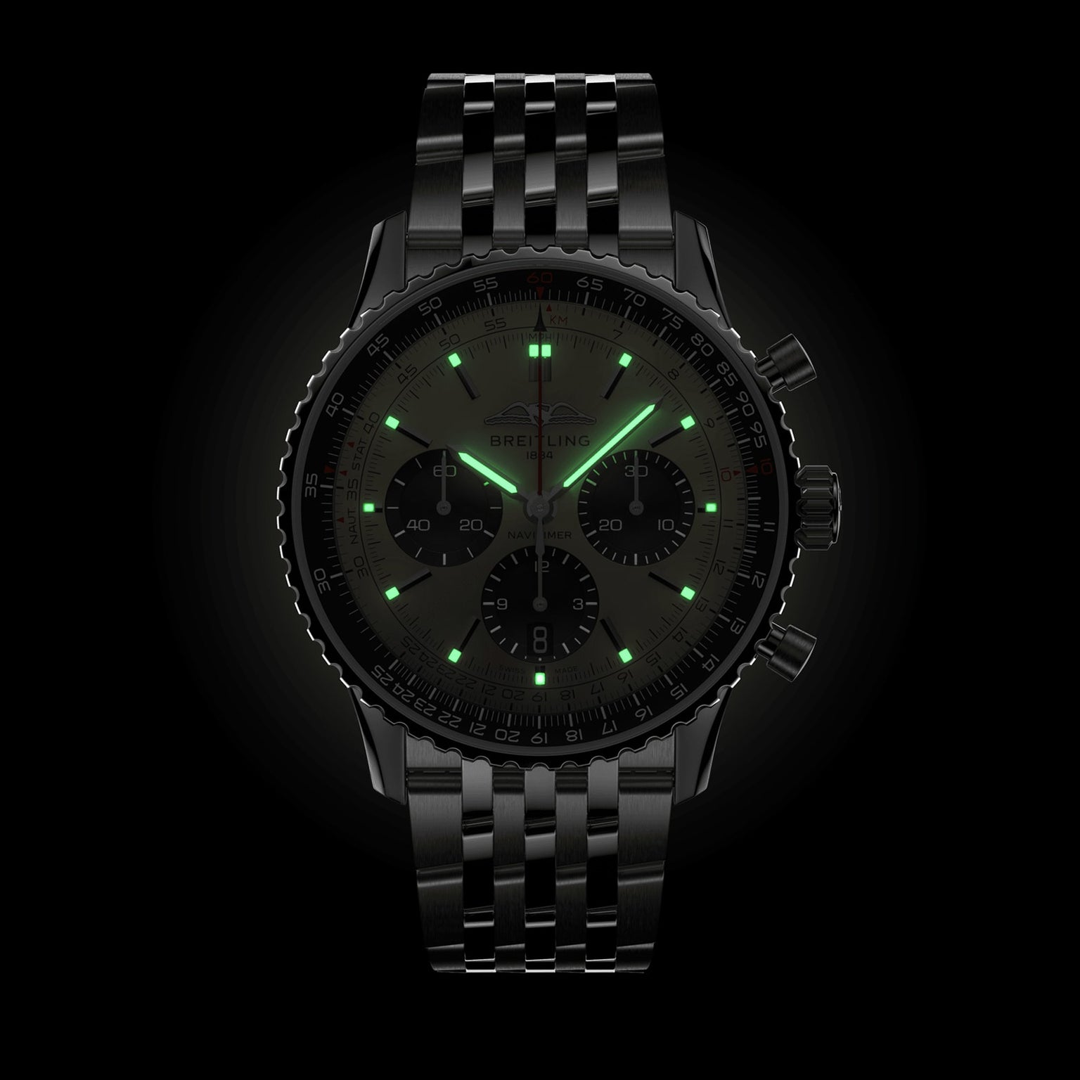 A Breitling Navitimer B01 Chronograph 43 pilot’s watch in black with a metal bracelet and glowing green markers and hands is displayed against a black background.