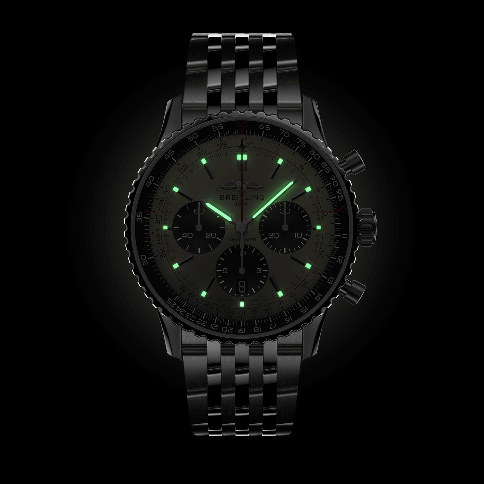 A Breitling Navitimer B01 Chronograph 43 pilot’s watch in black with a metal bracelet and glowing green markers and hands is displayed against a black background.
