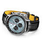 The Breitling Navitimer B01 Chronograph 43 features a light blue dial with three black subdials, a silver case, and a black leather strap with yellow lining and white stitching.