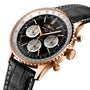 Close-up of the Breitling Navitimer B01 Chronograph 43, featuring a rose gold case, black dial with three subdials, and a black leather strap.