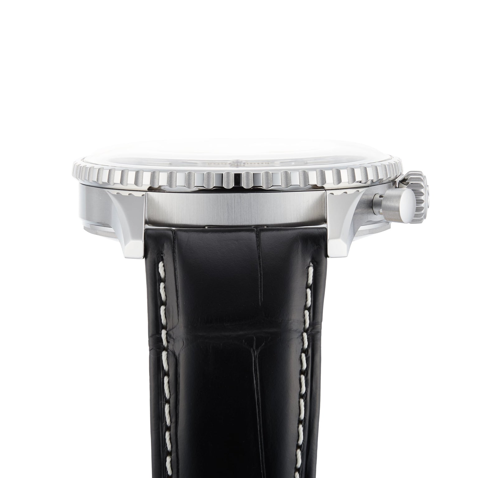 Side view of the Breitling Navitimer B01 Chronograph 46, showcasing its silver case, textured bezel, and black leather strap with white stitching, reminiscent of the iconic Navitimer design.