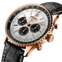 The Breitling Navitimer B01 Chronograph 46 is a gold watch with a black leather strap and a silver dial featuring three subdials.