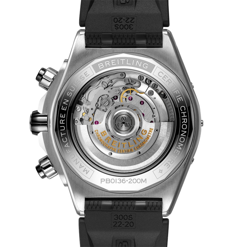 Close-up of the back of the Breitling Super Chronomat B01 44, revealing its visible mechanical chronograph movement, engraved branding, technical case details, and signature Rouleaux strap.