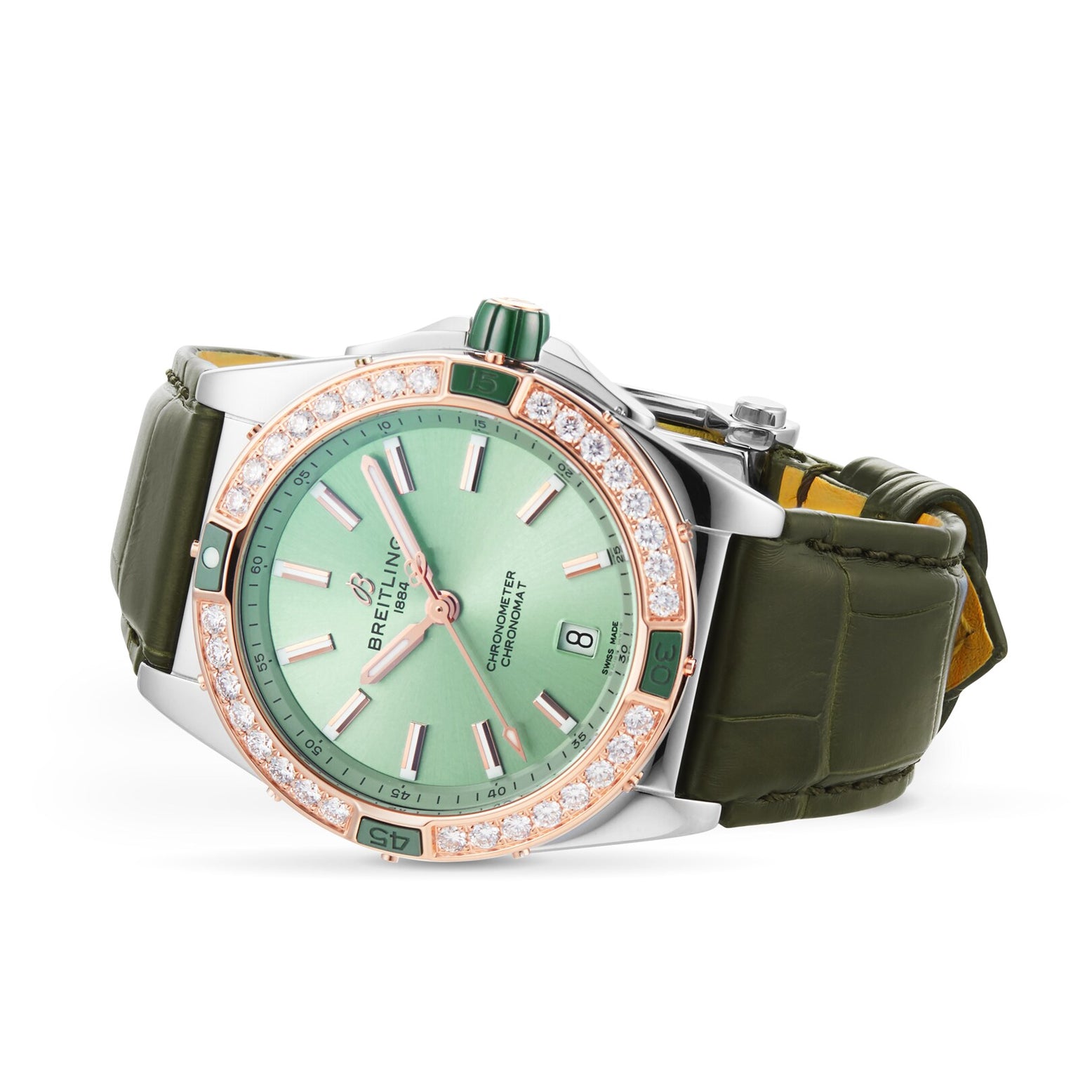 The Breitling Super Chronomat Automatic 38 features a green dial, diamond-set bezel, date display, green leather strap, and is powered by the Breitling 17 calibre movement—shown elegantly angled for a luxurious look.