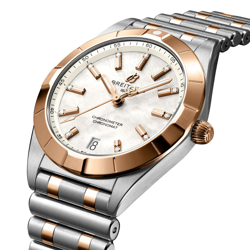 The Breitling Chronomat 32 features a white dial, gold hour markers, date at 6 o’clock, and a stainless steel & gold bracelet—a striking two-tone watch that exemplifies Breitling’s brilliance.