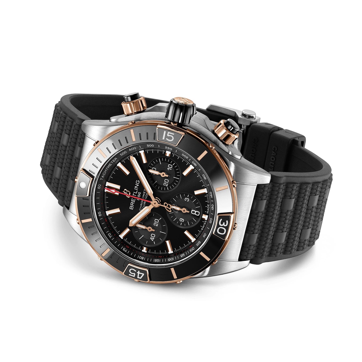 The Breitling Super Chronomat B01 44 is a luxury mechanical chronograph wristwatch featuring a black textured rubber strap, black dial with gold accents, and a stainless steel case, displayed on a white background.