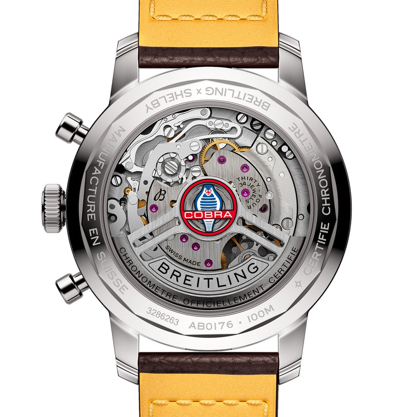 The back of the Breitling Top Time B01 Shelby Cobra chronograph showcases the Manufacture Calibre 01 movement, a Shelby Cobra logo, Swiss Made engraving, and a yellow and brown leather strap.
