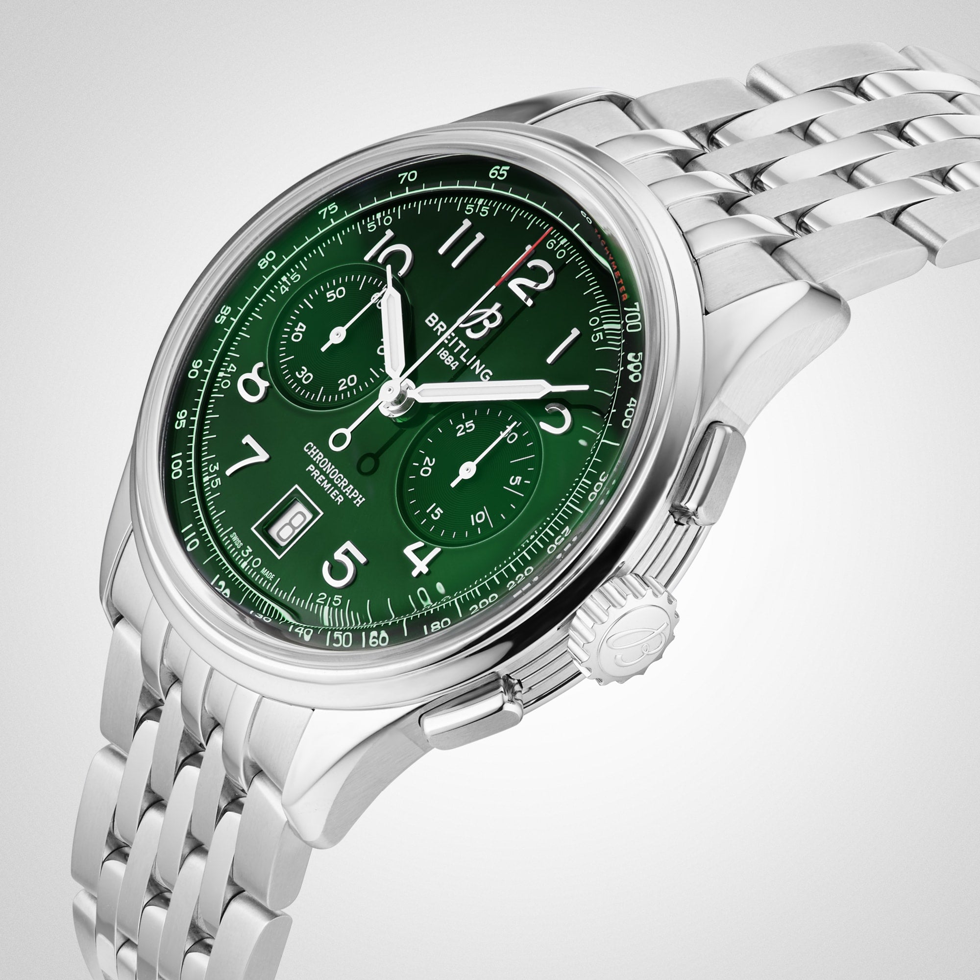 The Breitling Premier B01 Chronograph 42 boasts a stainless steel case, green chronograph dial with white Arabic numerals, three subdials, date window, and a polished silver metal bracelet.