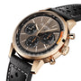 Breitling Top Time B01 gold chronograph wristwatch featuring a black leather strap and detailed brown dial, shown from an angle.