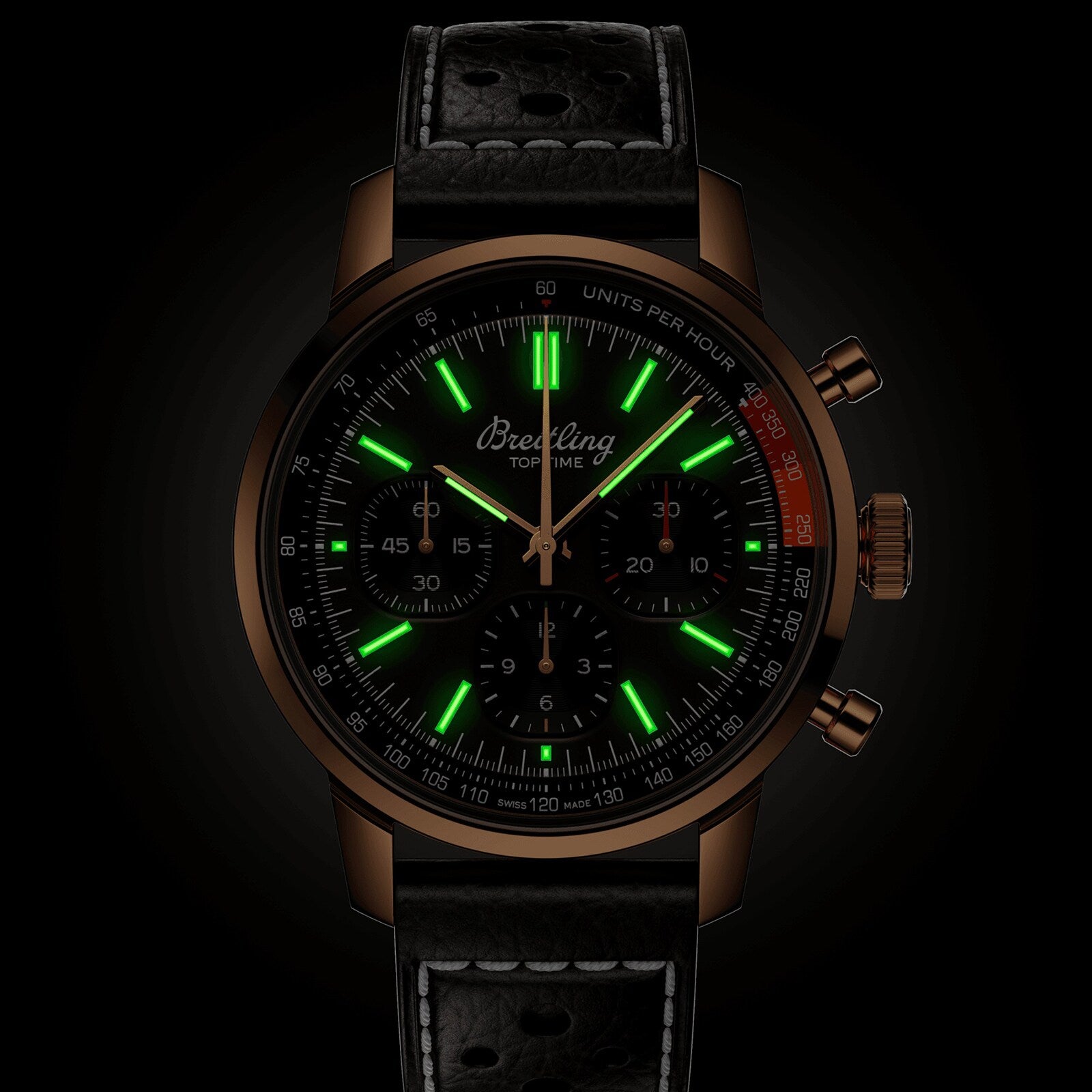 The Breitling Top Time B01 is a black watch featuring glowing green hour markers and a black leather strap.