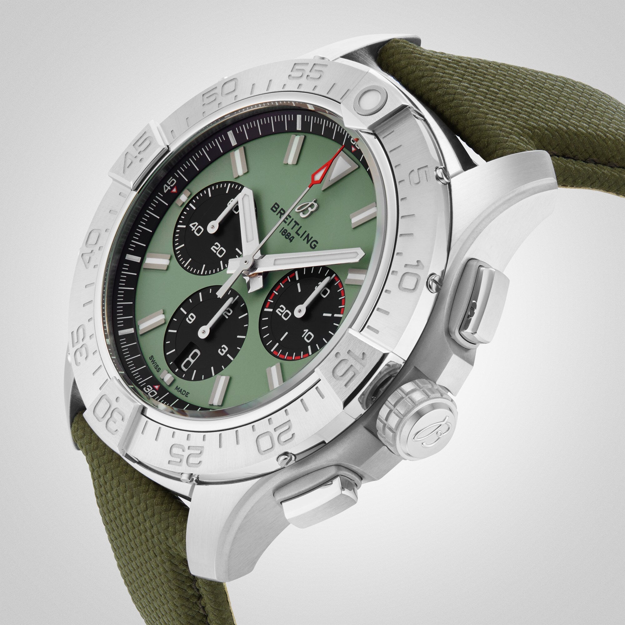 Close-up of the Breitling Avenger B01 Chronograph 44, featuring a green dial with black subdials, silver bezel, olive green fabric strap inspired by military uniforms, and a 70-hour power reserve.